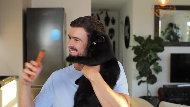 Man taking a selfie with a cat