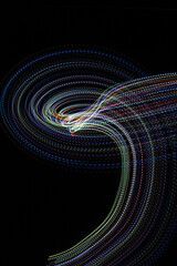 Long exposure light painting photography. Swirls of multicolor light in parallel lines against a black background