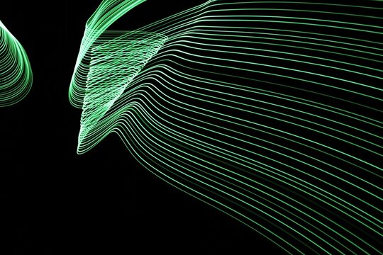 Long exposure light painting photography. Swirls of green light in parallel lines against a black background - Powered by Adobe