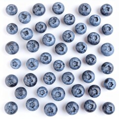 Fresh ripe blueberries scattered in a pattern on a clean white background top view.