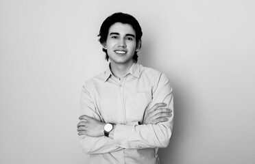 Handsome young college student in smart casual business attire wearing metal wrist watch