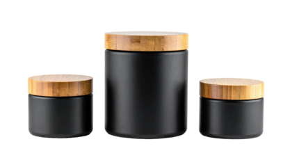 Three black jars with wooden lids, different sizes, centered on a black background