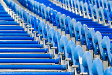 Fototapeta premium metal luggage trolleys close-up at airport, selective focus