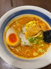 Tonkotsu Ramen noodles in shoyu soup, Ramen Japanese food very popular in asia. Ramen noodles served with pork, seaweed, onions, mushrooms and onsen eggs in shoyu soup or soy sauce soup on wood table.