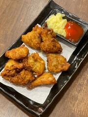 Deep fried chicken wings crispy and delicious thai sweet sauce on a wood table

