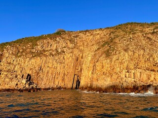 Sea Arch at Basalt Island in Sai Kung, Hong Kong UNESCO Global Geopark, Viewed from a Cruise Tour