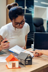 Vertical horizon Businesswoman real estate house agent discuss to customer. Team diversity women selling house real estate agent office desk. Vertical Women home insurance mortgage sale dealership