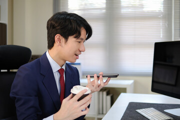 Businessman talking on the phone with speakerphone turned on