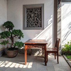Rustic Asian courtyard scene.  Wooden table and chair, bonsai, sunlit wall