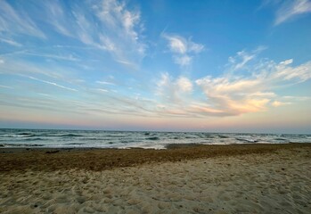 Serene beach at sunset with pastel sky and gentle waves