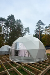 Geodesic domes for glamping and camping, thin-shell structure lattice shell based on geodesic polyhedron. Glamping is glamorous and camping, style of camping with amenities and resort style services.