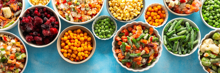Frozen summer vegetables like peas, carrots, and beans neatly displayed on plates, set against a calming blue background, preserving their freshness for winter use, banner