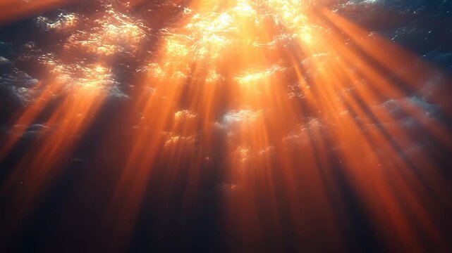 Dramatic underwater ocean background with fiery orange sun rays light beams shining through surface for religious church worship video and global warming heat concept