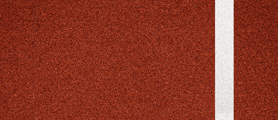 Close-up view of red running track surface with a white lane marking, ideal for athletics themes, sport backgrounds, fitness concepts and training-related design materials.