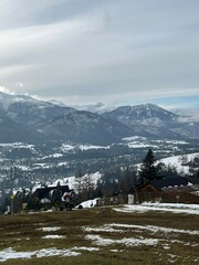 Scenic mountain village with patchy snow and cloudy sky  © János István Lukács