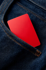 A close-up image of a vibrant red card tucked into the pocket of blue denim jeans, symbolizing casual style and everyday life.