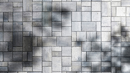 Geometric gray paving stones background with soft shadows and sun lights