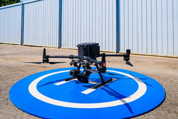 Industrial quadcopter stands on the runway