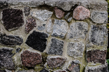 Close-up of rough natural stone wall with varied stones