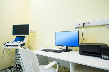 A modern medical treatment room or operating room equipped with medical equipment with a screen.