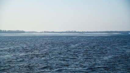Snow river winter landscape. Frozen ice and snow by river.