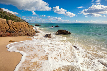 Galapinhos beach on a sunny day. Rocky seascape. Setubal region, Atlantic Ocean, Portugal