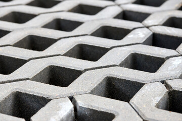 Checkered Concrete Cinder Tiles Of A Garden Sidewalk Lawn In Palette. Turf Grass Block Paving Stones. Grasscrete is eco friendly material for driveways, parking lots or garages instead of concrete