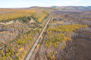 Aerial photography of the autumn forest railway in the Greater Khingan Range