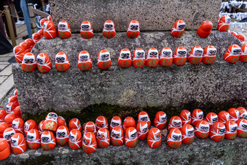 Collecting daruma dolls at a temple in Japan during a sunny day in early spring