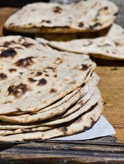 Stack of Rustic Indian Roti on a Wooden Table
