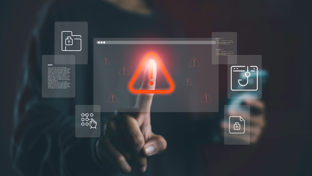 Data security threat alert and malware risk. Pointing at glowing red warning icon on virtual screen, representing cybersecurity breach, data protection error, and digital system vulnerability. - Powered by Adobe