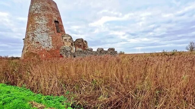 The historical ruins of St Benet&rsquo;s Abbey and monastery on the river bank of the River Bure in the heart of the Norfolk Broads. Captured on a dull and overcast autumn day