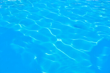 Clear blue water surface with gentle ripples and reflections of light