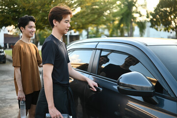 An Asian LGBT couple prepares to leave after exercising, captured in a calm and affectionate everyday scene