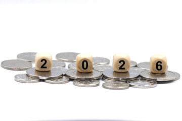 2026 description on the wooden blocks laying on coins, concept for personal income tax for 2026.