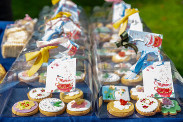 Colorful iced cookies in clear boxes with ribbons and tags, ready for giving