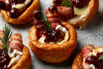 Stuffed Yorkshire Puddings with pig in blankets, camembert cheese and cranberry sauce