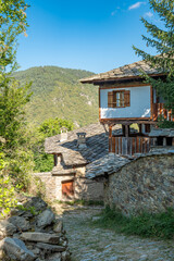 A narrow stone street between old, historic houses in the village of Kovachevitsa in the Rhodope Mountains, Bulgaria
