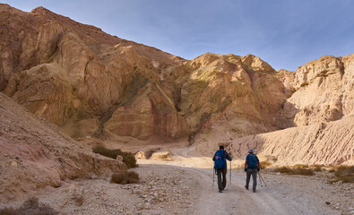 Unique landscape in Eilat Mountains nature reserve, the southern Negev, as seen from the Israel Trail pass through the reserve. A group of hikers in a hiking trail. Active lifestyle. A weekend hike.