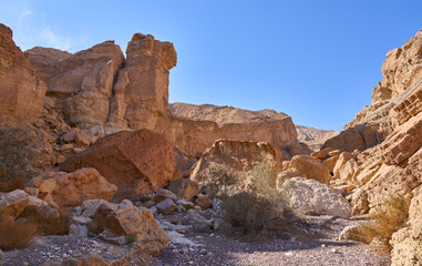 Unique landscape in Eilat Mountains nature reserve, southern Negev, as seen in Israel Trail that passes through the reserve. Huge boulders in a hiking trail. Weekend in the nature with whole family.