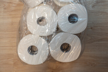 A close-up view of rolled white towels packaged and stacked together, showcasing their soft texture and pristine appearance, ideal for home, hospitality, or wellness themes.