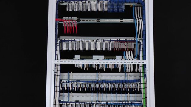 The reverse side of the electrical switchboard. The connected wires are tied with plastic ties.
