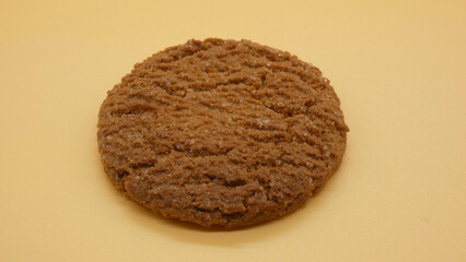 Baking session showing freshly baked cookie placed on a yellow surface