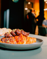 Chocolate topped croissant served on a plate, showcasing artisanal bakery products, caf&eacute; lifestyle, and modern dessert presentation. Publique bakery, popular tourist destination in Melbourne
