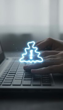 Close up of a programmer's hands typing on a laptop keyboard with a flickering blue triangular error sign with an exclamation mark, representing a system malfunction or cybersecurity threat