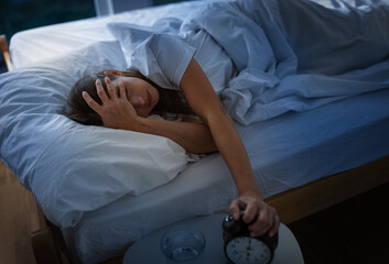 Waking up to an alarm clock in a bedroom