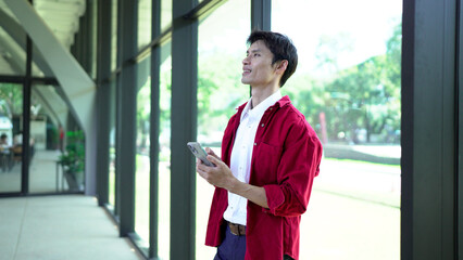 Business man using smart phone in office space background and copy space