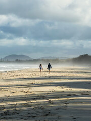 Couple walking on a misty beach