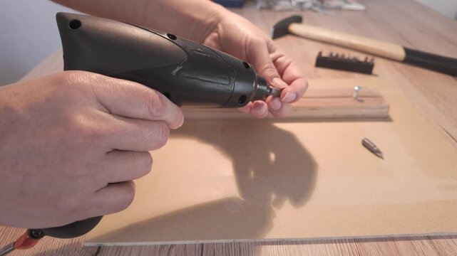 Hands changing screwdriver bit showing right side details