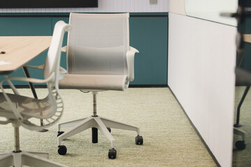 Modern office interior with swivel chair, desk corner, cabinets and light decor